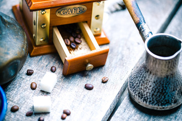 Fresh coffee in cezve on wooden table