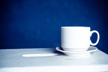 mug on wooden table over grunge background