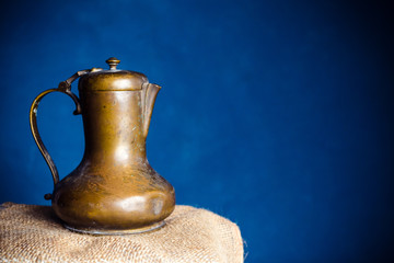 Old antique teapot on table