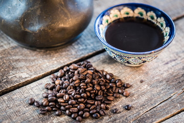 Coffee cup and coffee beans on wooden background. Top view