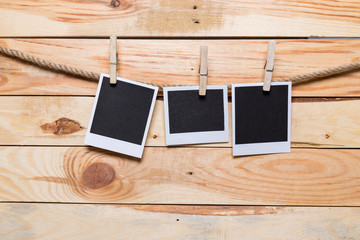 Notes and a clothes pegs on wooden background