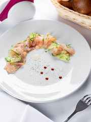 sliced fish fillet with cucumber and pea leaves