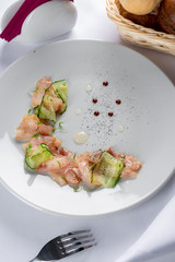 sliced fish fillet with cucumber and pea leaves