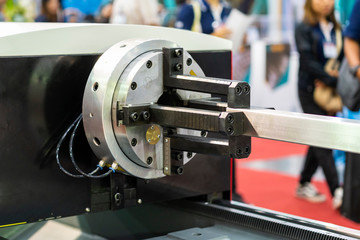 close up work piece metal square pipe during clamp by auto chuck rotate set for high precision automatic laser cutting machine or other