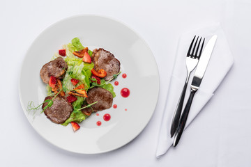 beef stake with strawberry on white dish