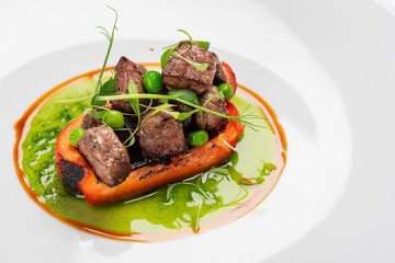 fried bell pepper stuffed with beef slices with fresh peas and basil sauce