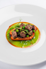 fried bell pepper stuffed with beef slices with fresh peas and basil sauce
