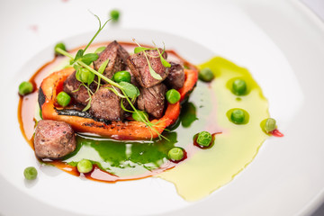 fried bell pepper stuffed with beef slices with fresh peas and basil sauce