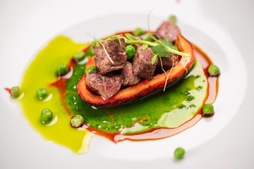fried bell pepper stuffed with beef slices with fresh peas and basil sauce