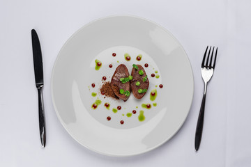 fried beef tongue with young peas, basil sauce and grated walnut