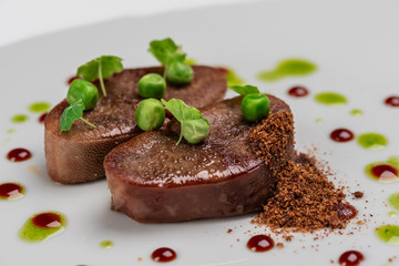 fried beef tongue with young peas, basil sauce and grated walnut