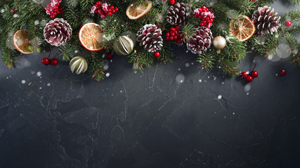 Festive Christmas greeting layout template with fir branches decorated with natural dried decor of...