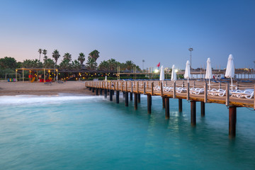 Beautiful scenery with wooden pier on Turkish Riviera at sunset, Side