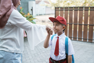 portrait of child shake hand and kissing hand before school