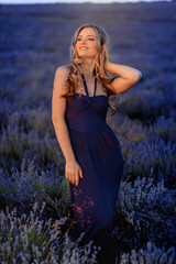 Beautiful girl on the lavender field. Beautiful woman in the lavender field on sunset.