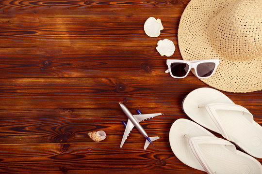 Vacation travel equipment Straw hat, sunglasses And marine objects, shells, on wooden floor - Image