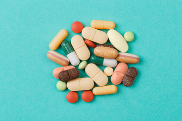 colour tablets and pills on blue background .