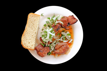 shish kebab on white plate isolated on black background top down view of traditional pork meat grilled food served with sauce onion salad and white bread look from above natural color of barbeque meal