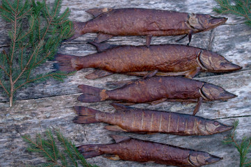 smoked fish on a wooden table, top view. close up