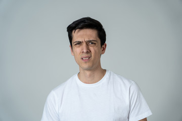 Portrait of a young man looking scared and shocked. Human expressions and emotions