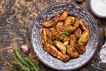 Baked young potatoes in a rustic style with sour cream