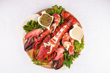 Mediterranean cuisine, lobster stuffed with cabbage, greens and sauces