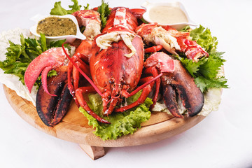 Mediterranean cuisine, lobster stuffed with cabbage, greens and sauces
