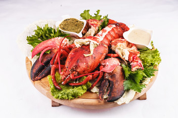 Mediterranean cuisine, lobster stuffed with cabbage, greens and sauces
