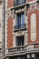 Naklejka premium Old French house with traditional balconies and windows. Paris, France.