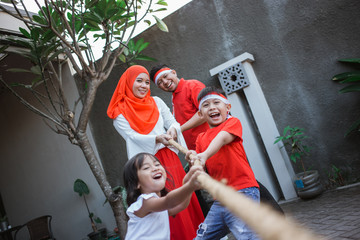 family tug of war during indonesia independence day celebration together