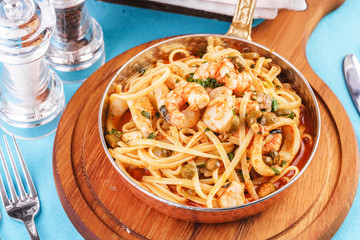 Mediterranean pasta with shrimps, onions, cucumbers and hot peppers