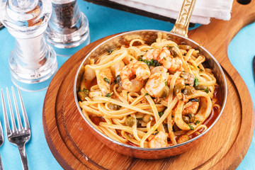 Mediterranean pasta with shrimps, onions, cucumbers and hot peppers