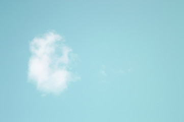 Cloud resembling ear isolated on teal blue sky background
