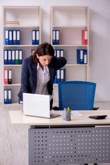 Fototapeta na wymiar Middle-aged female employee suffering in the office