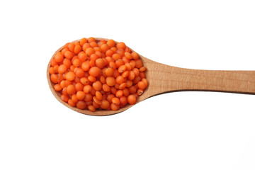 red lentils in wooden spoon isolated on white background. Top view.