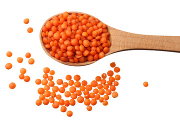 red lentils in wooden spoon isolated on white background. Top view.