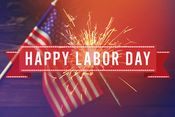 Sparkler and USA flag on wooden background. Independence Day celebration