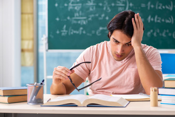 Young male student in the classroom