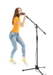 Teenage girl with microphone singing against white background