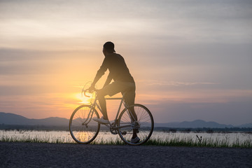 Cyclist on background of sunset, sport and travel concept