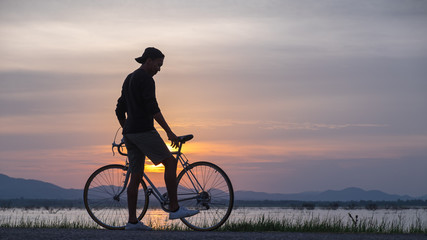 Obraz premium Cyclist on background of sunset, sport and travel concept