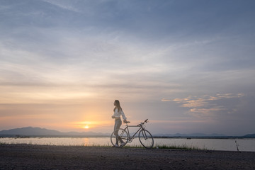 Fototapeta premium Cyclist on background of sunset, sport and travel concept