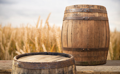 Beer barrel with beer glasses on a wooden table. The dark brown background.