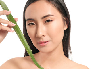 Beautiful Asian woman with aloe vera on white background