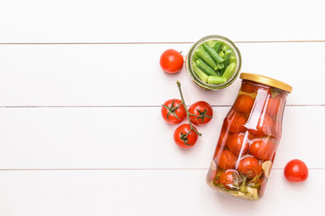 Naklejka na ściany i meble Jars with different canned vegetables on white wooden background