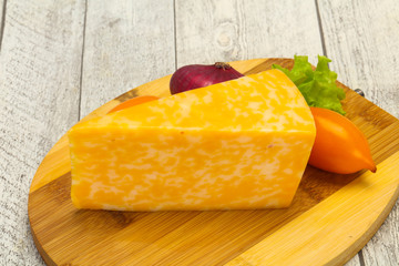 Marble cheese  triangle over wooden