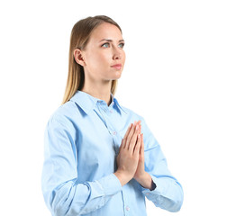 Religious young woman praying on white background