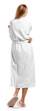Beautiful young woman in bathrobe on white background, back view