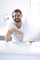 Businessman in the office on the phone with headset, Skype