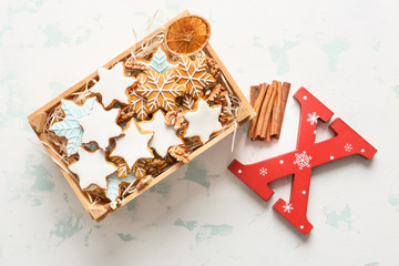 Box with tasty Christmas cookies on light background